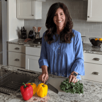 Stephanie cutting vegetables in kitchen